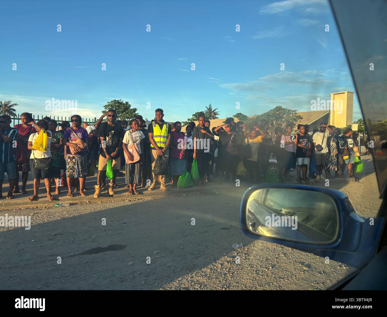 People waiting for transport near Central Market, Mendana Ave, Honiara, Guadalcanal, Solomon Islands. No MR - Smartphone Captured Stock Image