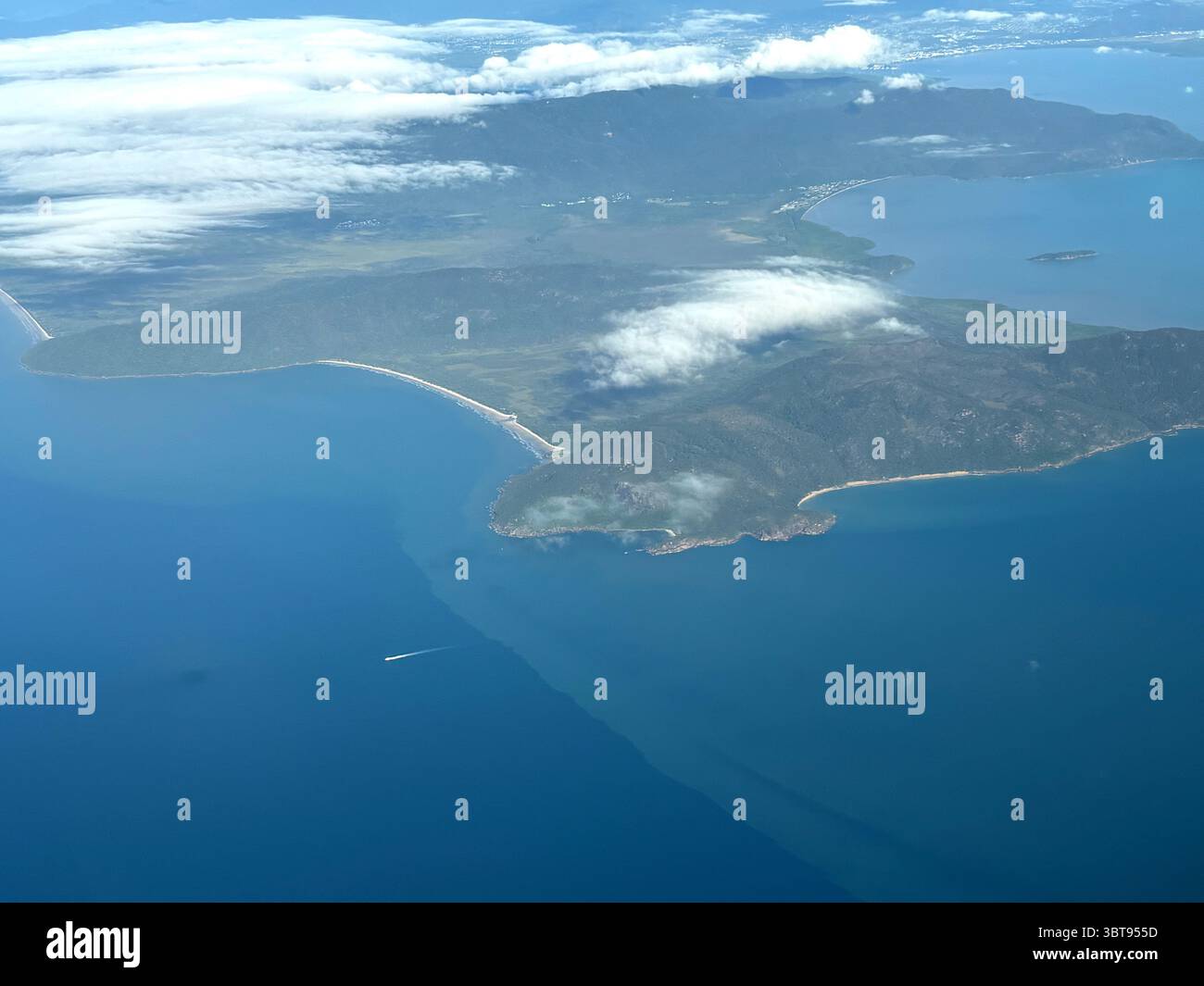 Aerial view over Cape Grafton showing low salinity flood plume moving up coast and out to the GBR, near Cairns, Queensland, Australia. May 2025 - Smartphone Captured Stock Image