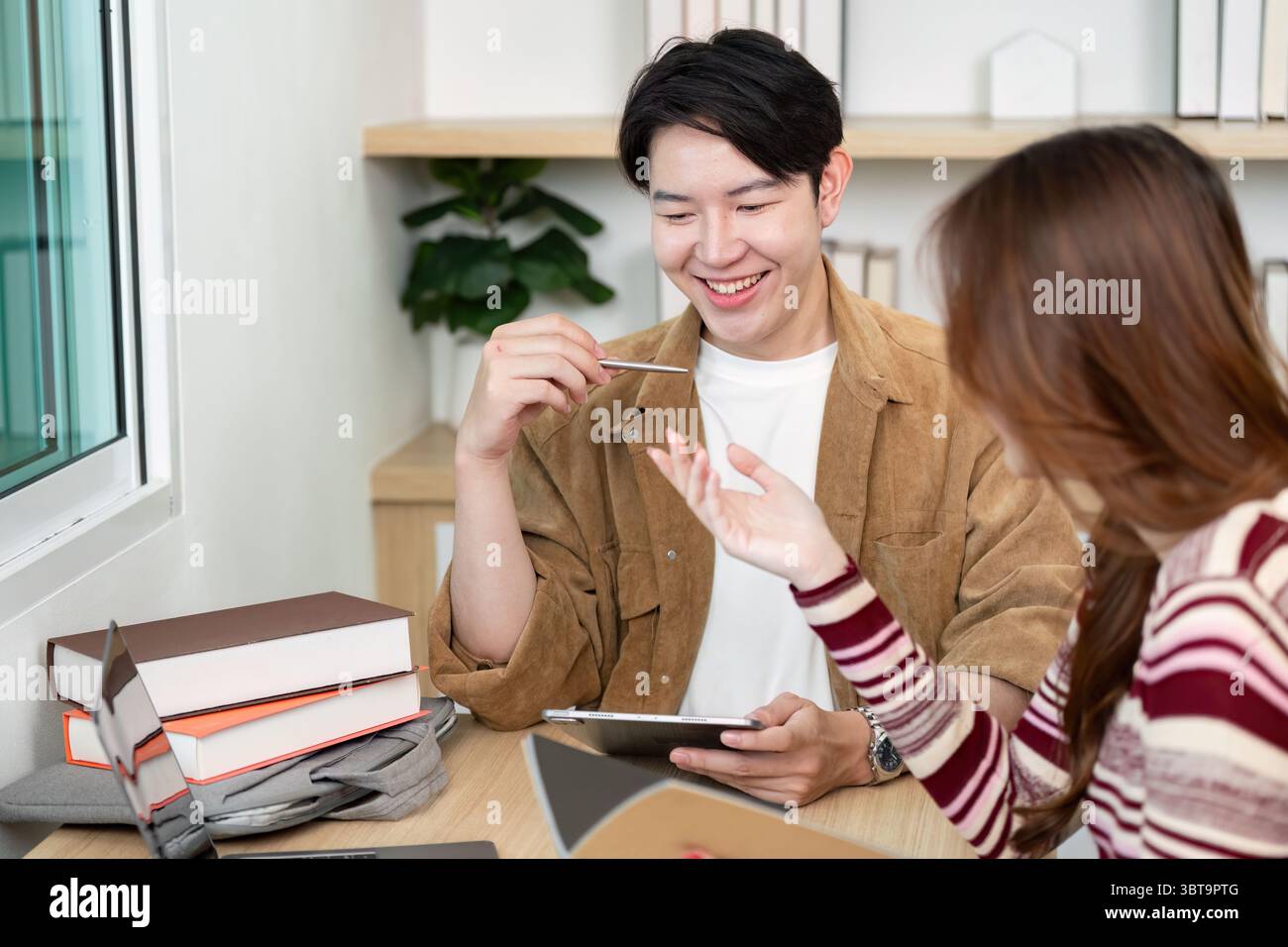 Back to School. Students collaborating on academic projects in a modern study space. Stock Photo