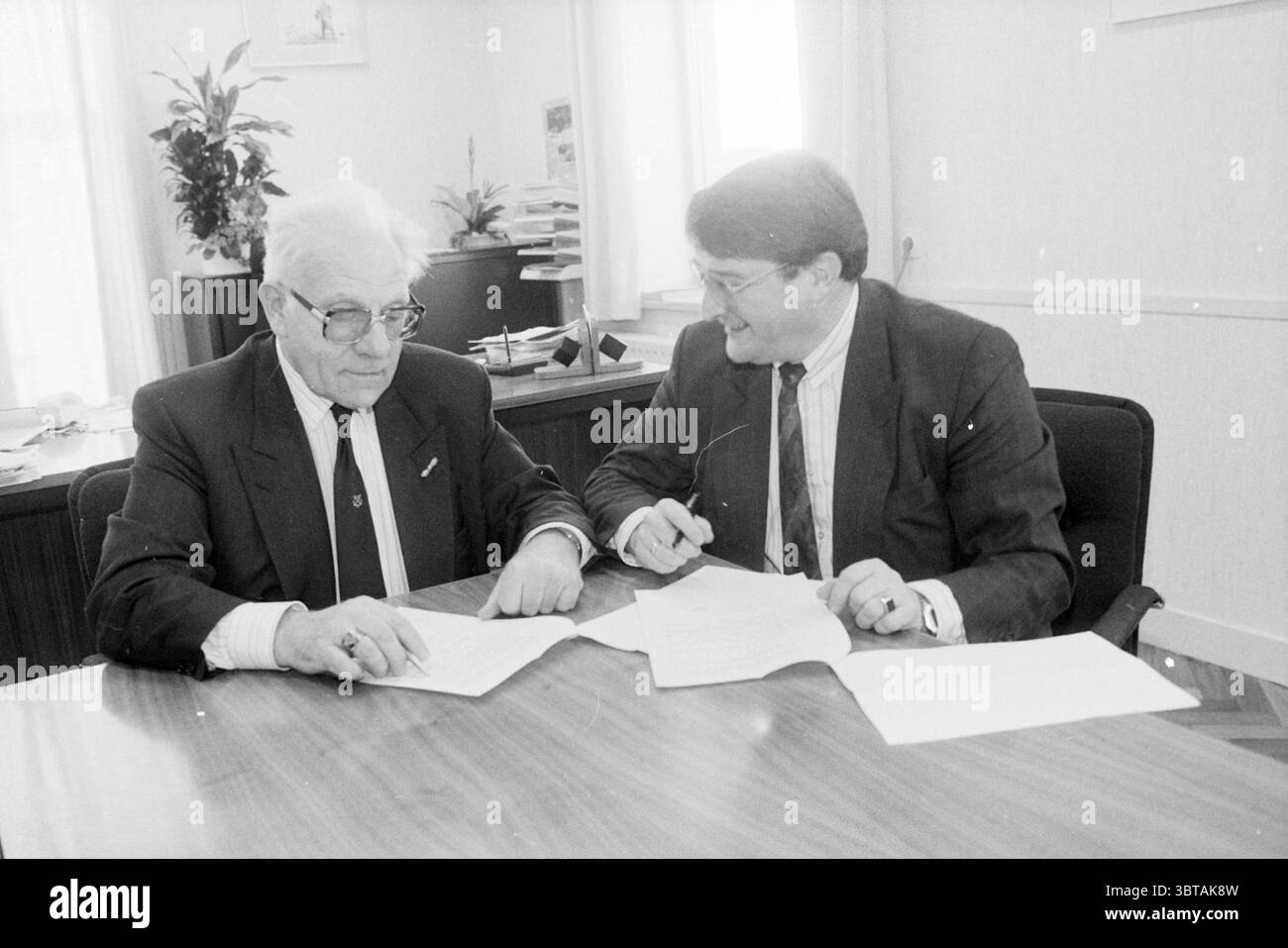 1950 2000 two men sign documents hi-res stock photography and images ...