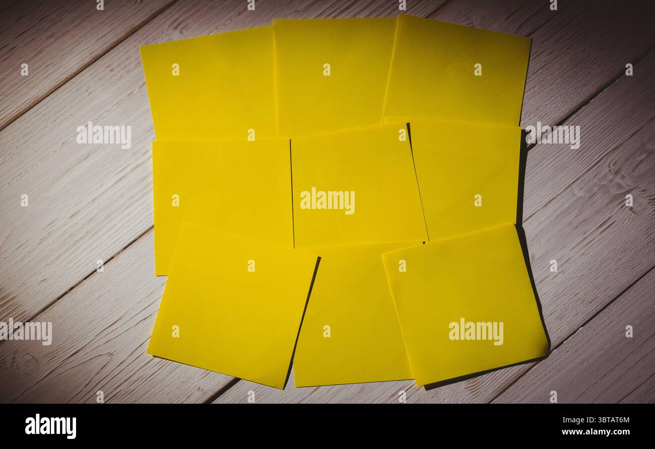 Yellow papers on wooden floor Stock Photo