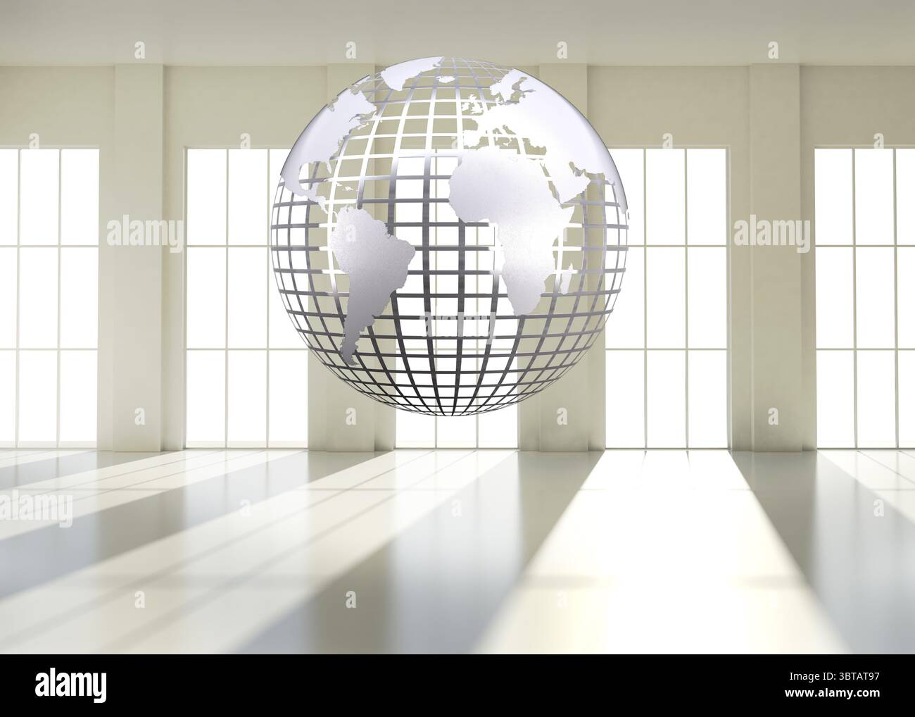 Silver globe floating in room Stock Photo
