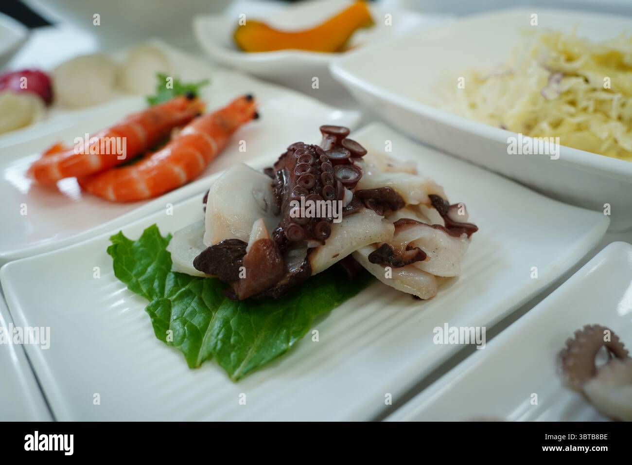 Assorted Seafood Platter with Octopus on White Plates Stock Photo