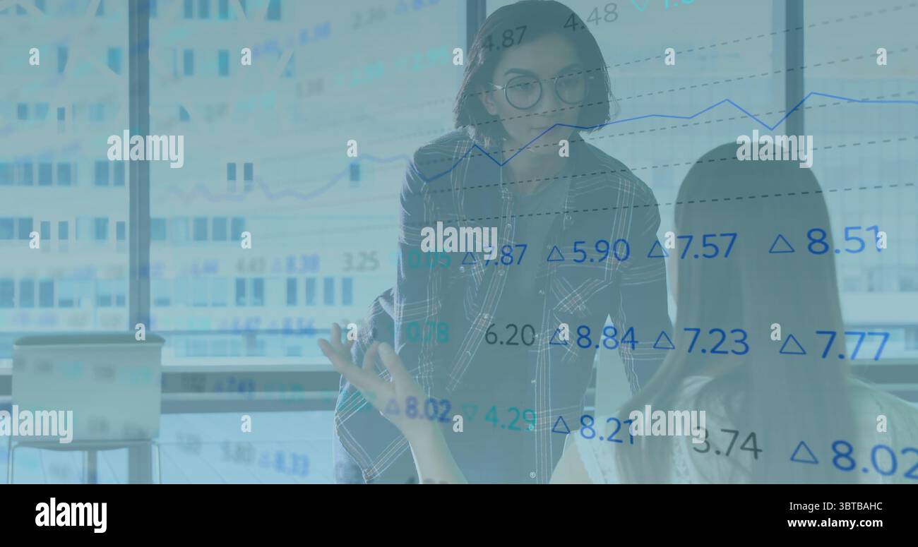 Collaborating women wearing business attire analyzing data in meeting ...