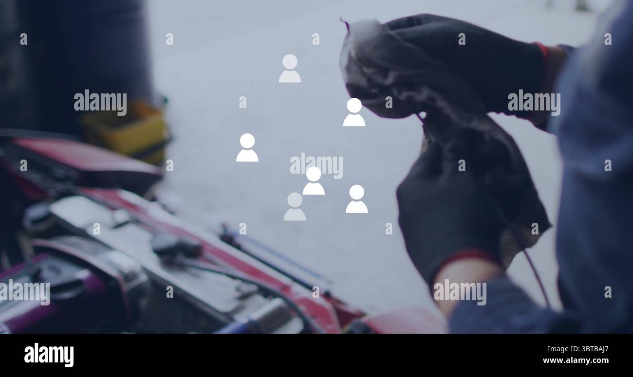 Car Engine Rag Cleaning mechanic wiping engine in garage, with rag by red car hood ...