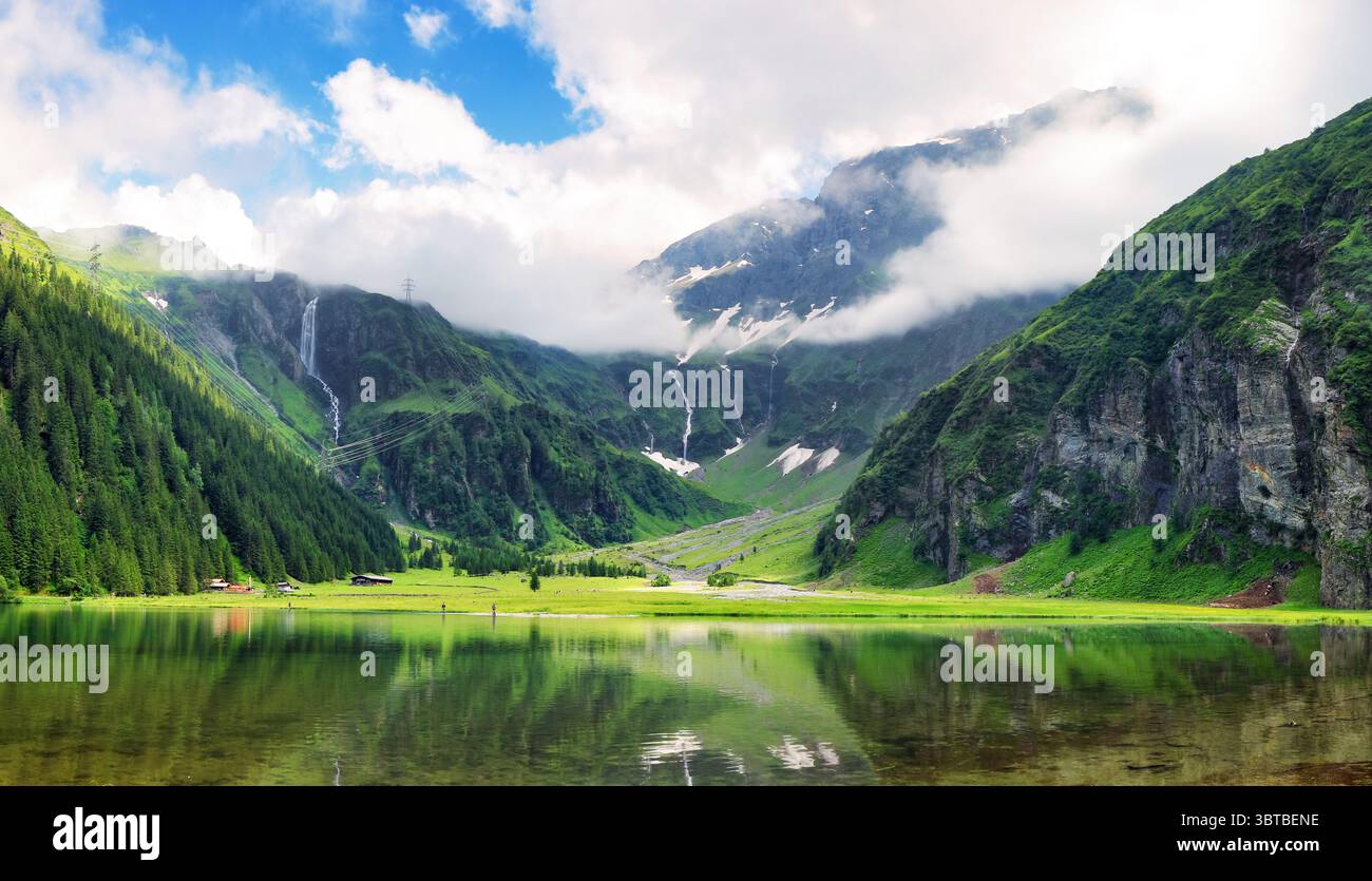 Beautiful summer lake landscape with mountain in the Autria Alps. Wonderful hiking spot. Alpine lake with high mountains. Pine trees. Hohe Tauern near Stock Photo