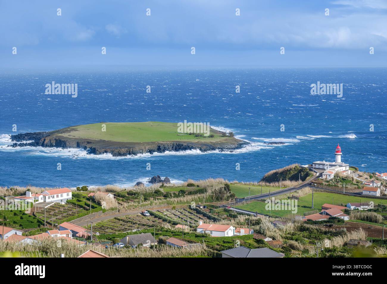 Ponta do Topo Lighthouse And Islet View From Sao Jorge Azores Portugal. Atlantic island landscape, coastal village, dramatic cliffs, traditional Portu Stock Photo