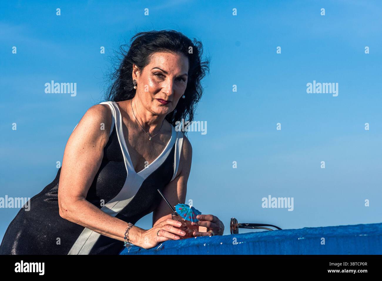 Long black hair blue dress hi-res stock photography and images - Alamy