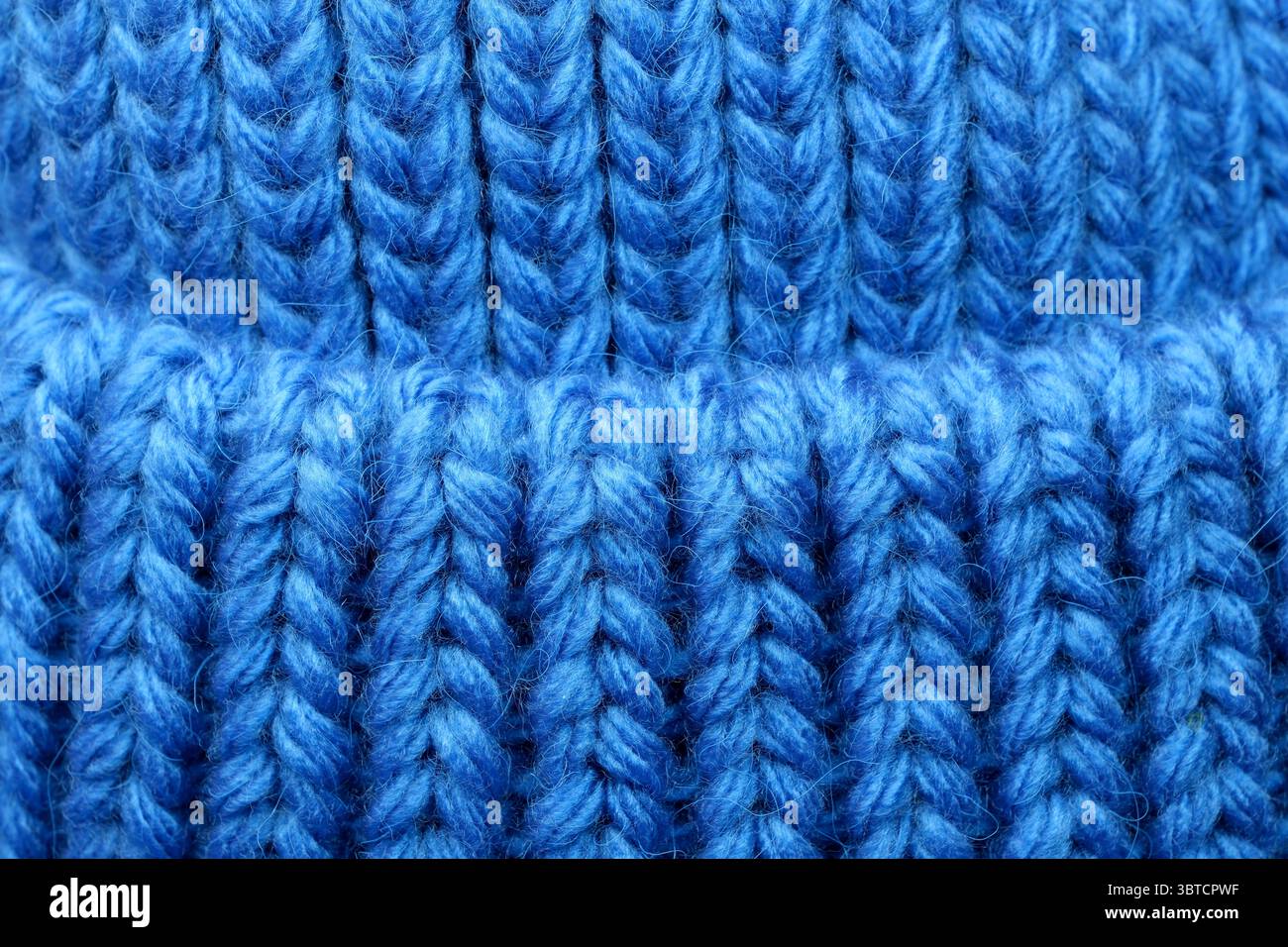 Textile blue background large knitted wool fabric, close-up background, macro photography Stock Photo