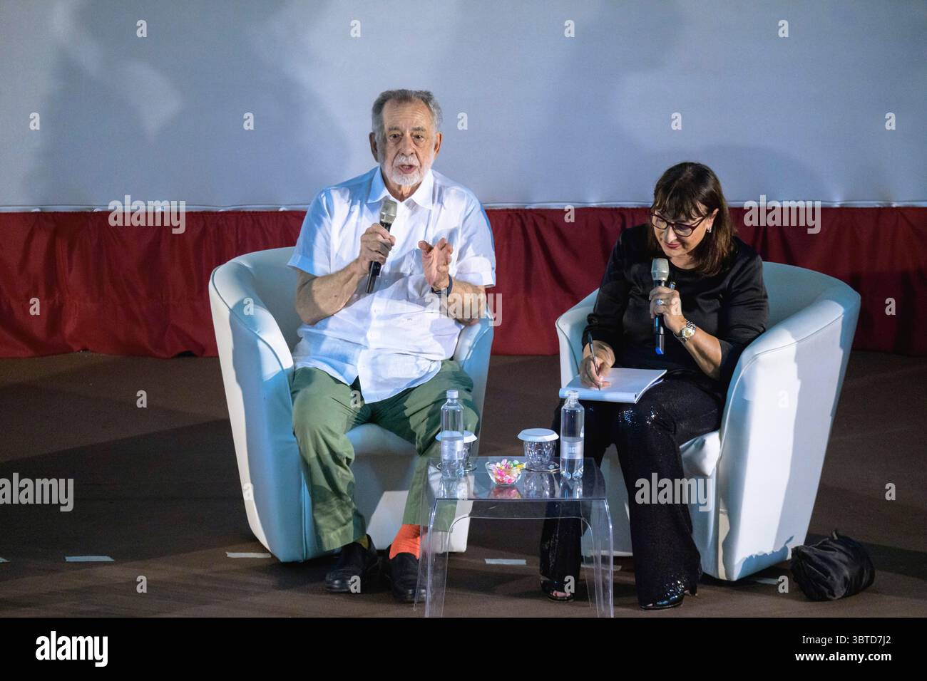 Legendary movie director Francis Ford Coppola (L) and interpreter Bruna
