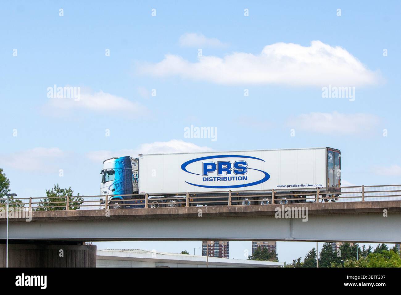 Prs Distribution A blue and white PRS Distribution articulated lorry travels with a ...