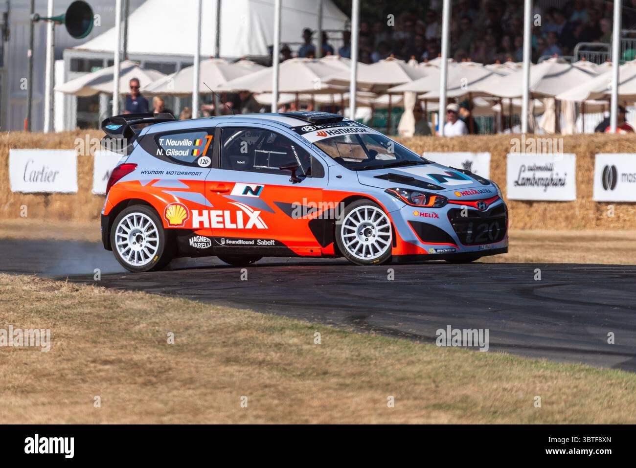 2014 Hyundai i20 WRC rally car driving up the hillclimb track at the ...