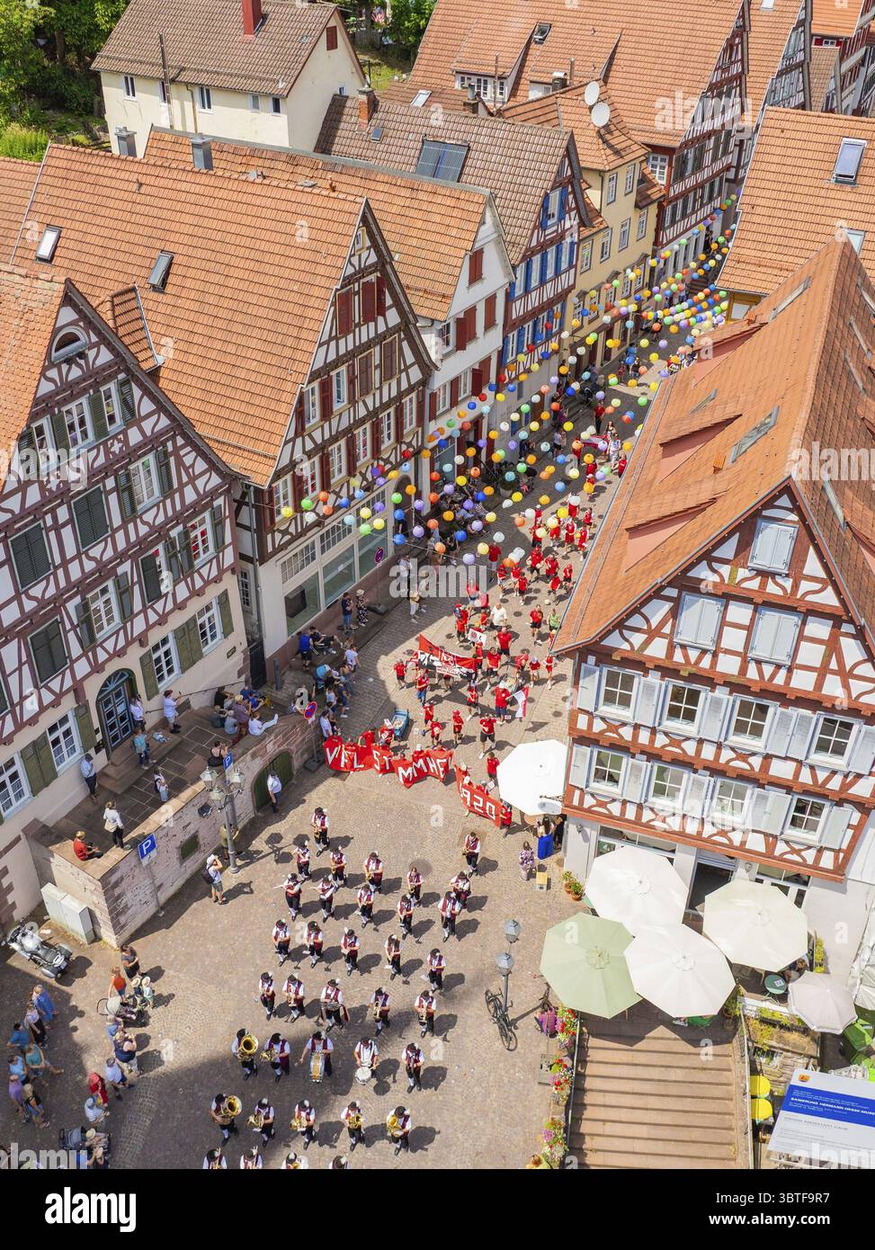 A colourful event with lots of balloons and people between historic ...
