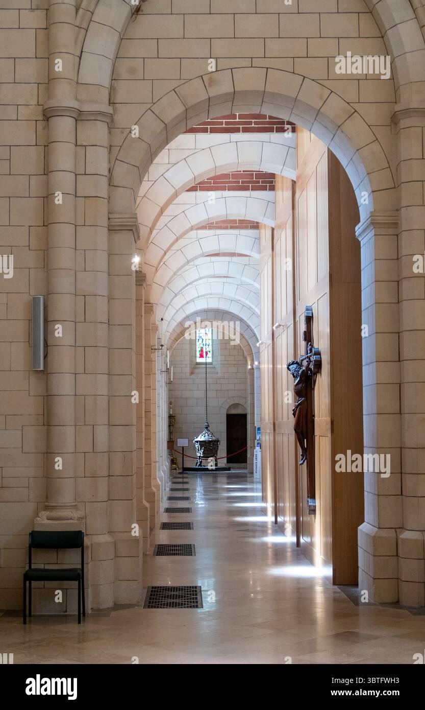 Side passage leading to the font at Buckfast Abbey, Buckfastleigh, Devon, home to a community of Benedictine monks, a monastic order of the Roman Cath Stock Photo