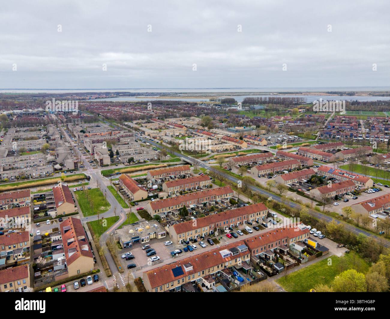 Aerial view of neat rows of houses with red-tiled roofs contrasting ...