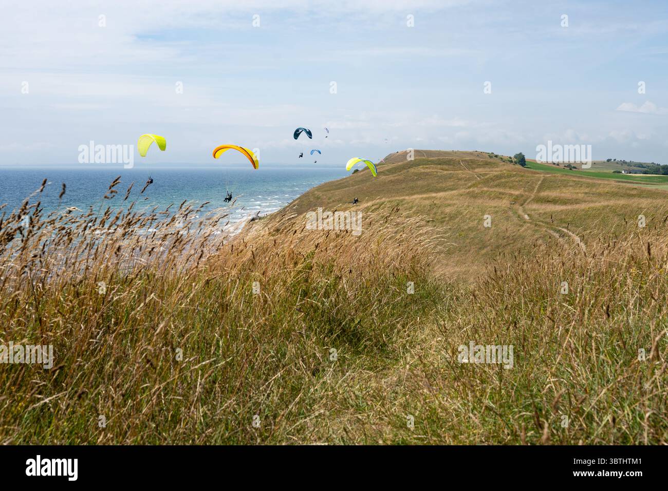 Paragliders and hang gliders above the Hammar Hills, Kaseberga, near Ystad as seen from the Osterlen Way long distance way footpath, Sweden Stock Photo