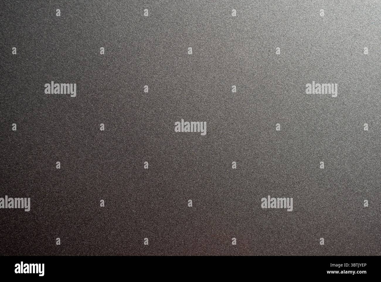 Full frame background texture of dark grey brushed metallic surface with subtle light gradient. Stock Photo