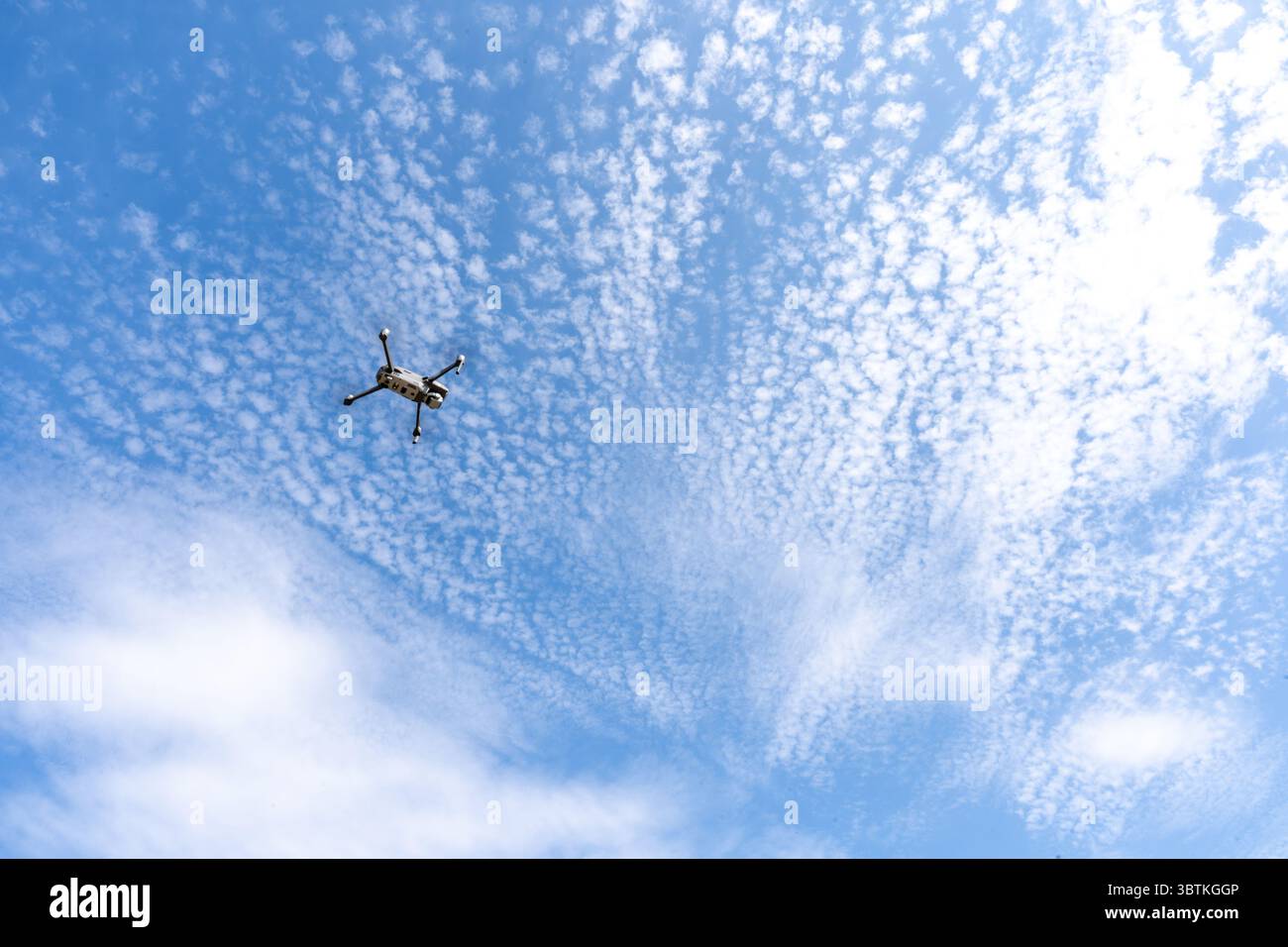 Drone Flying High in Blue Sky with Scattered Clouds – Aerial Technology ...