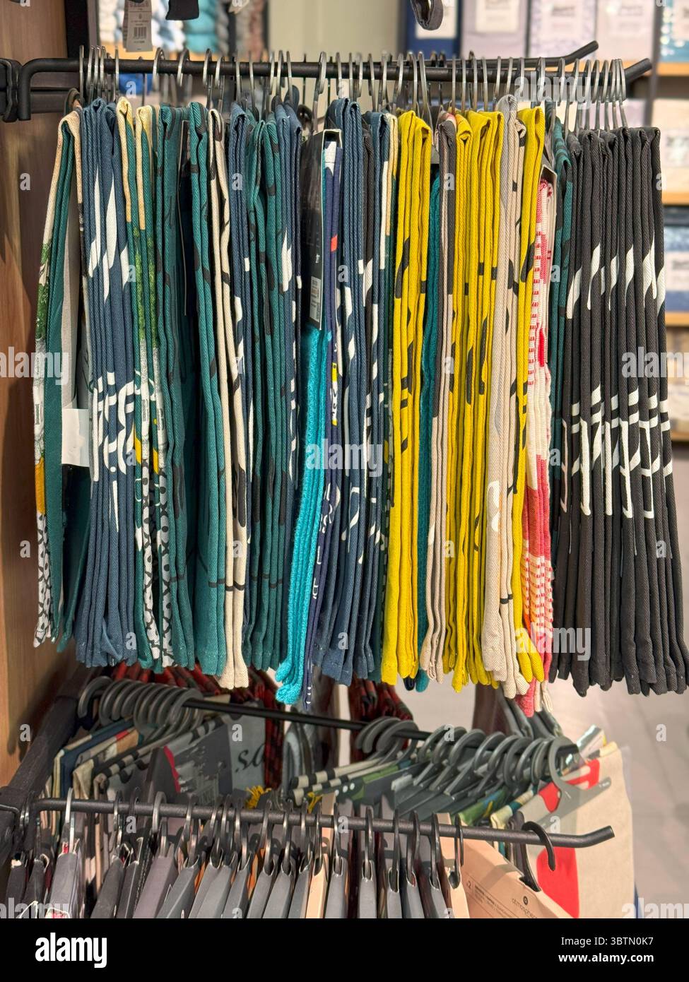 Hanging Printed Bandanas in Earth-Tone Palette,Organized Textile Rack Stock Photo