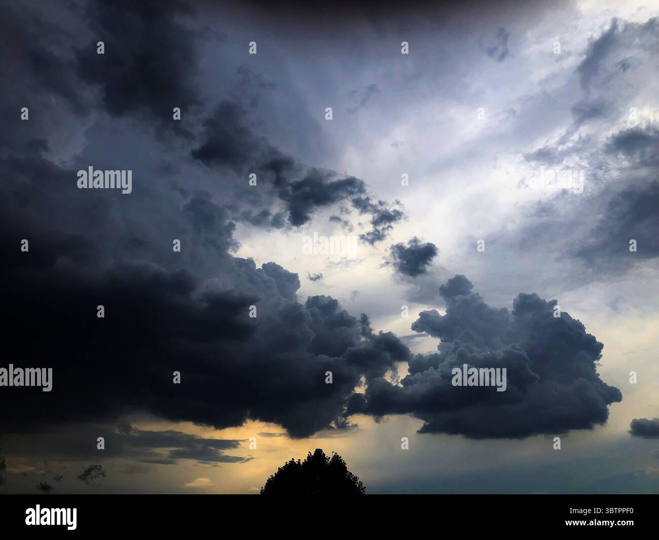 The Sun Setting Behind a Clearing Storm Stock Photo