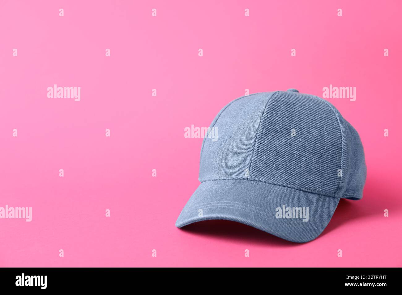 Denim baseball hat on pink background, closeup. Space for text Stock Photo