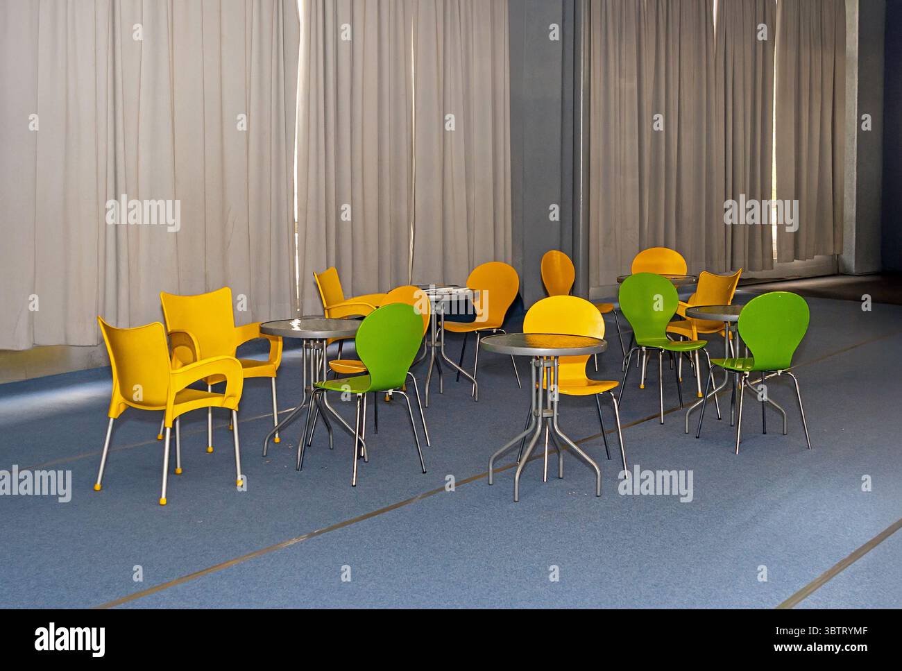 Retro colorful plastic chairs and tables inside empty cafe interior Stock Photo