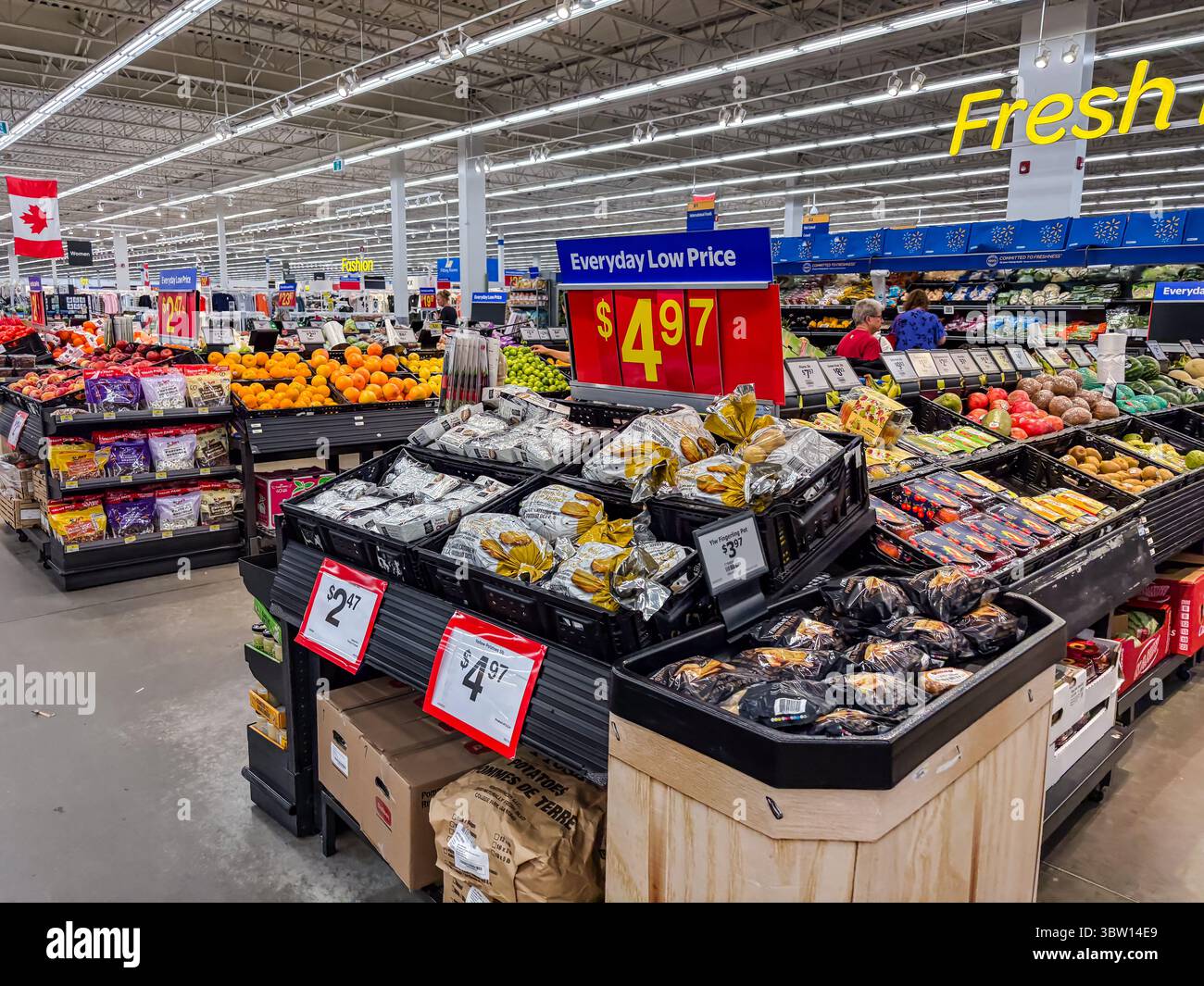 Walmart interior view of the produce section in Canada, showing fresh fruits, vegetables, pricing, and everyday low price signage. Stock Photo