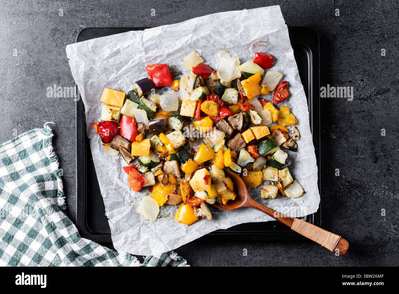 Roasted vegetabes on black slate background Stock Photo