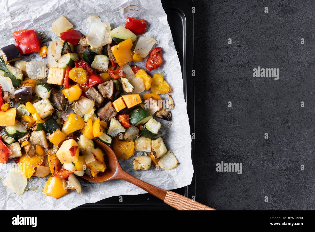 Roasted vegetabes on black slate background Stock Photo