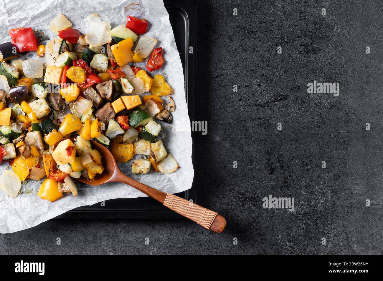 Roasted vegetabes on black slate background Stock Photo
