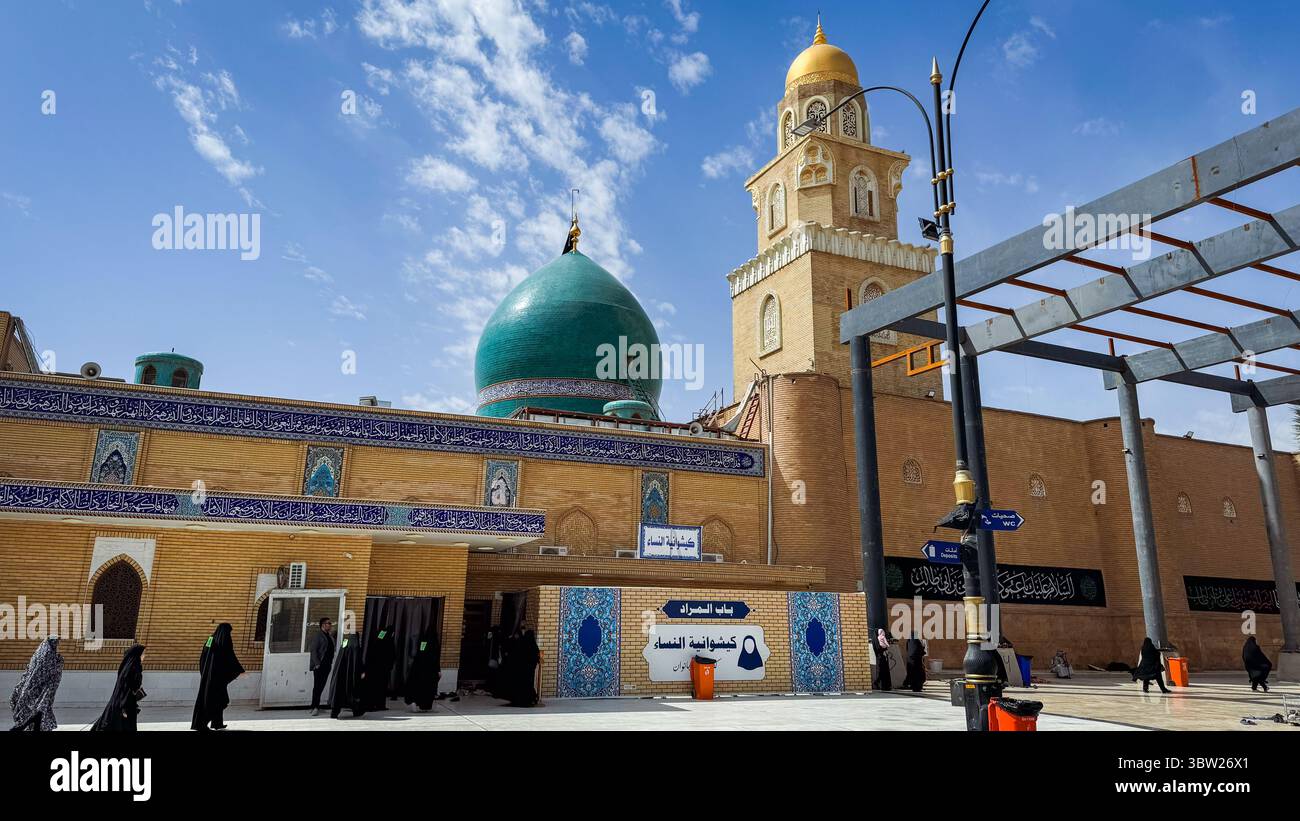 Local visitors engage with a prominent mosque complex in Kufa, Iraq ...