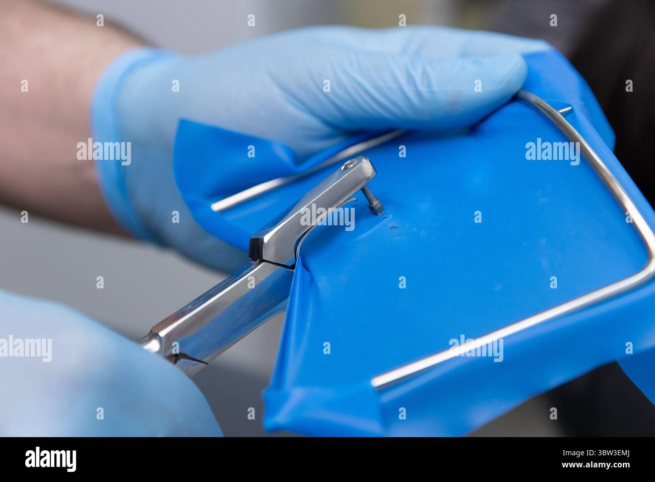 Healthcare Professional Handling Surgical Instrument with Blue ...