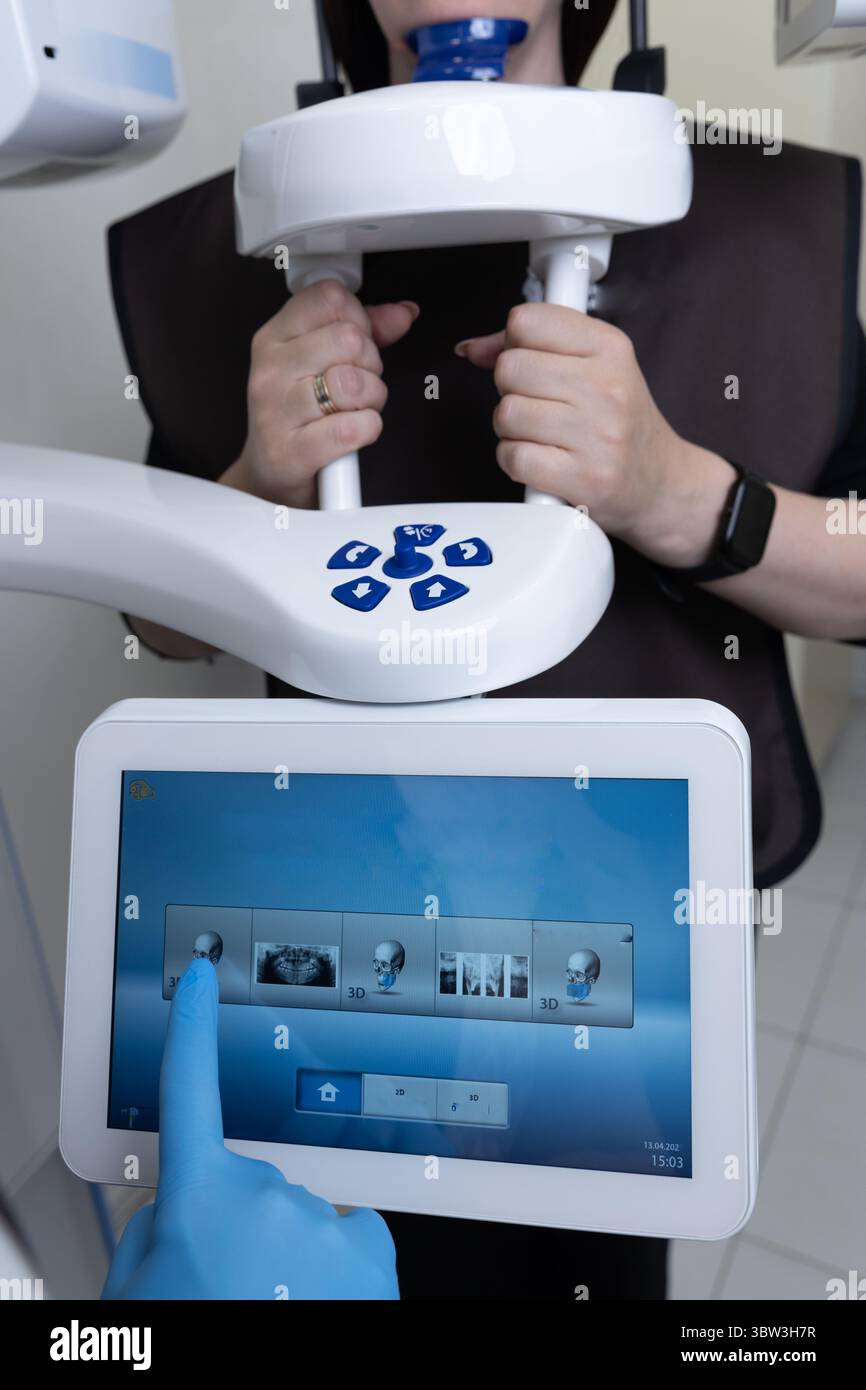 Advanced Dental Imaging Technology: Patient Preparing for 3D X-ray Scan with Digital Control Interface and Safety Features Stock Photo