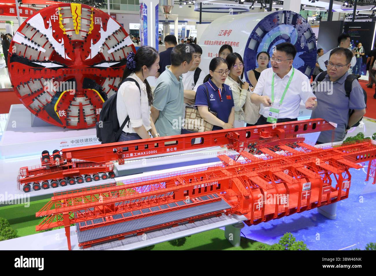 Visitors check out models of bridge construction machines and tunneling ...