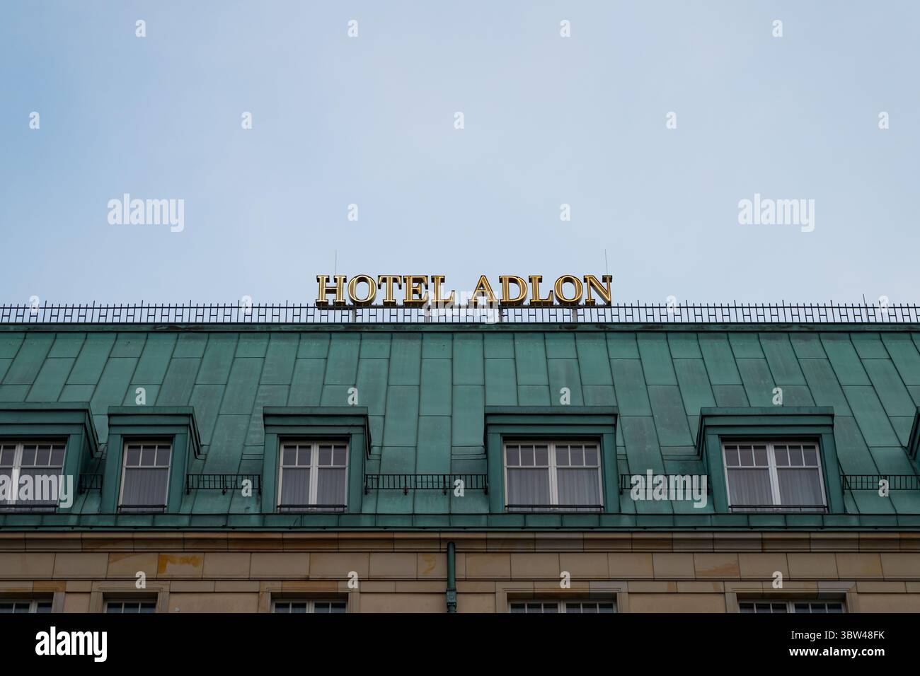 Hotel Adlon logo sign on top of the building exterior in Berlin, Germany. Illuminated name signage of the luxury hotel belonging to Kempinski. Stock Photo