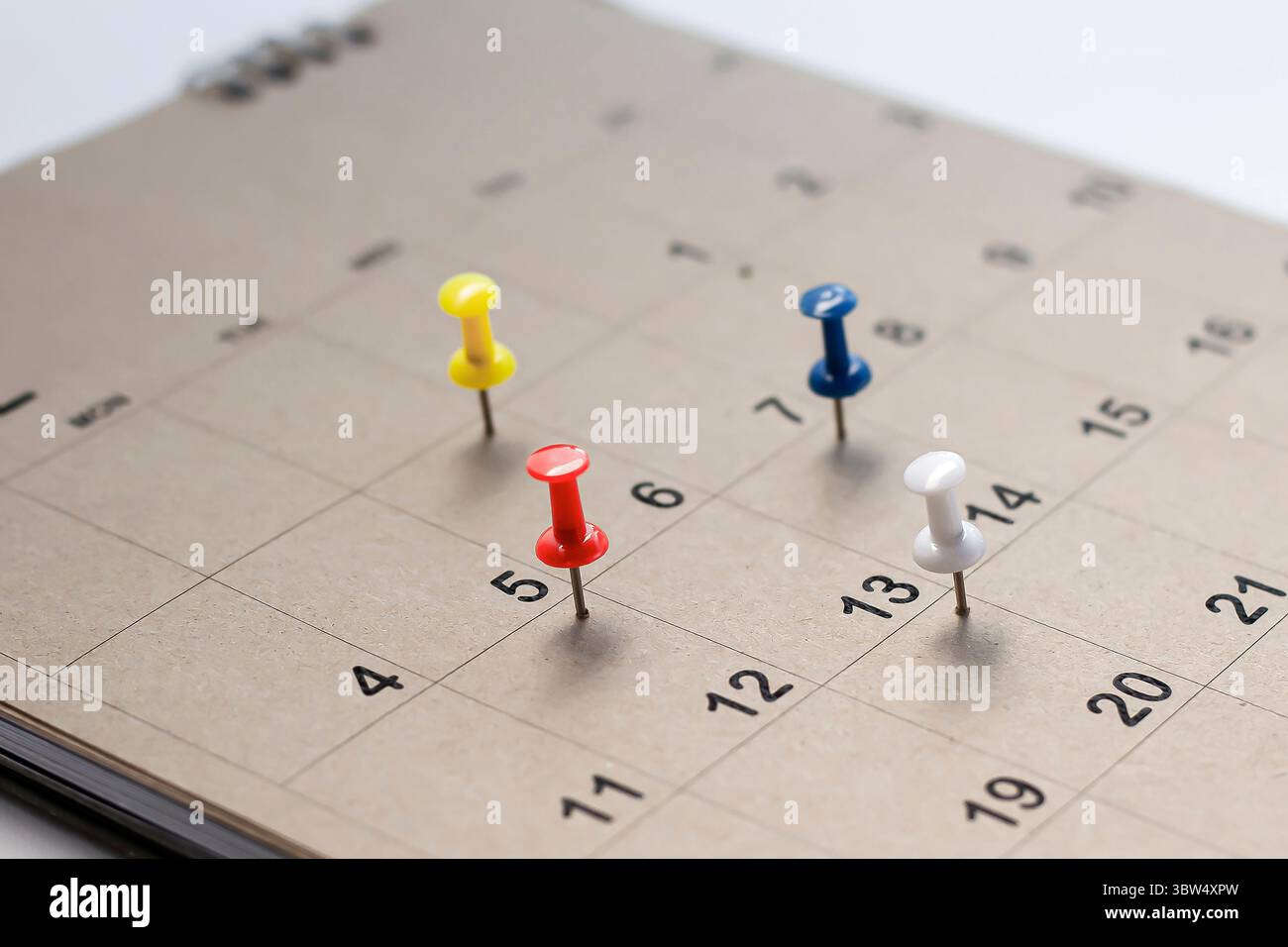 Embroidered pins on a calendar appointment Stock Photo