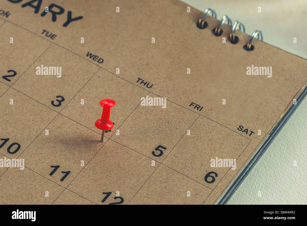Embroidered pins on a calendar appointment Stock Photo
