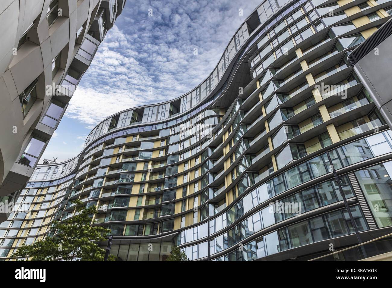 Modern residential complex featuring striking glass balconies ...