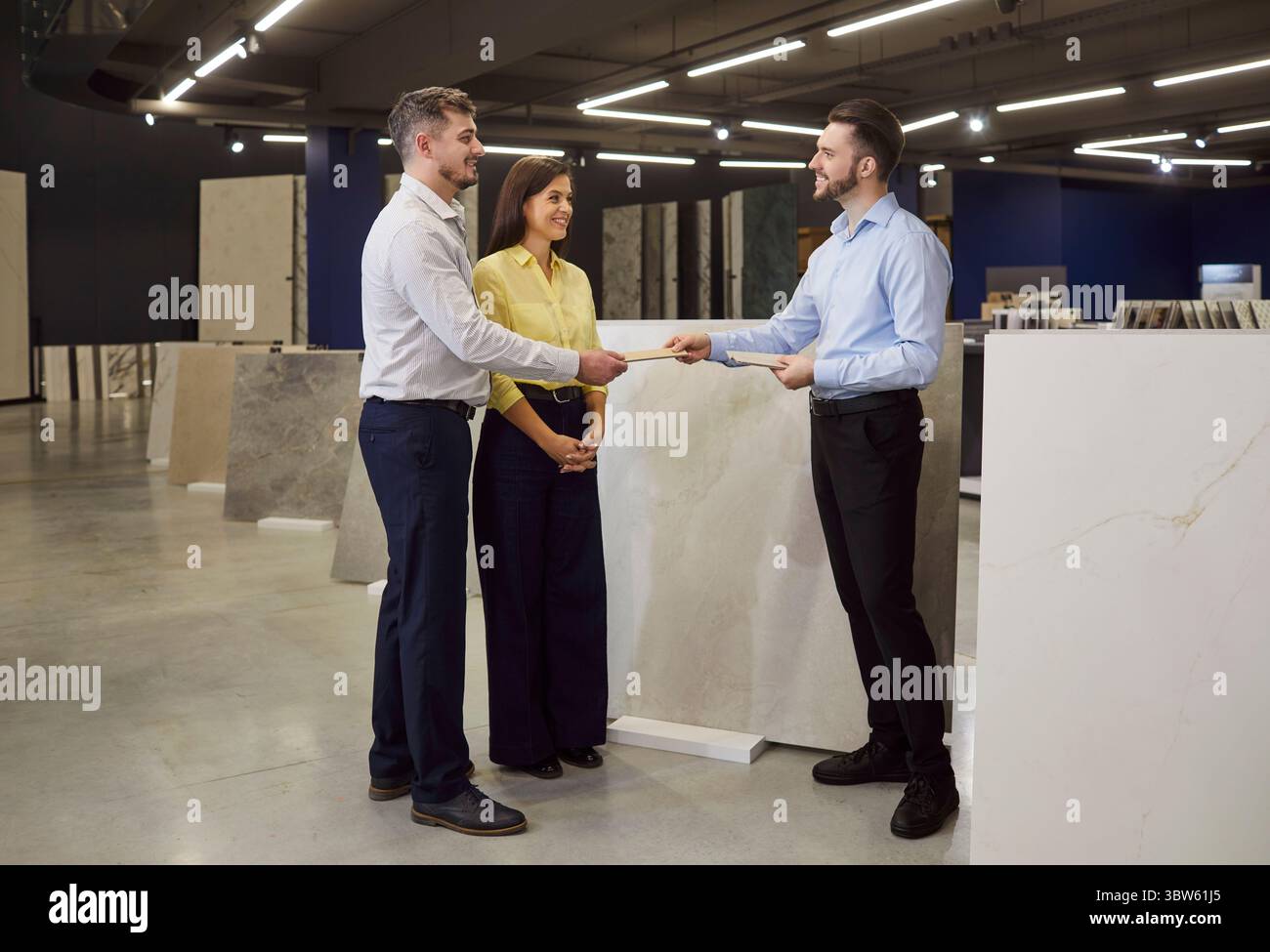 Consultant Advising Family Couple In Hardware Shop Stock Photo