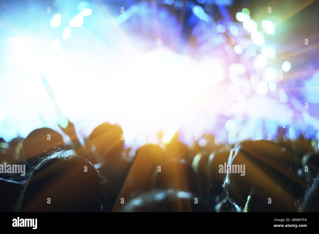 Rock concert with silhouettes people in happy gesture and raising up ...