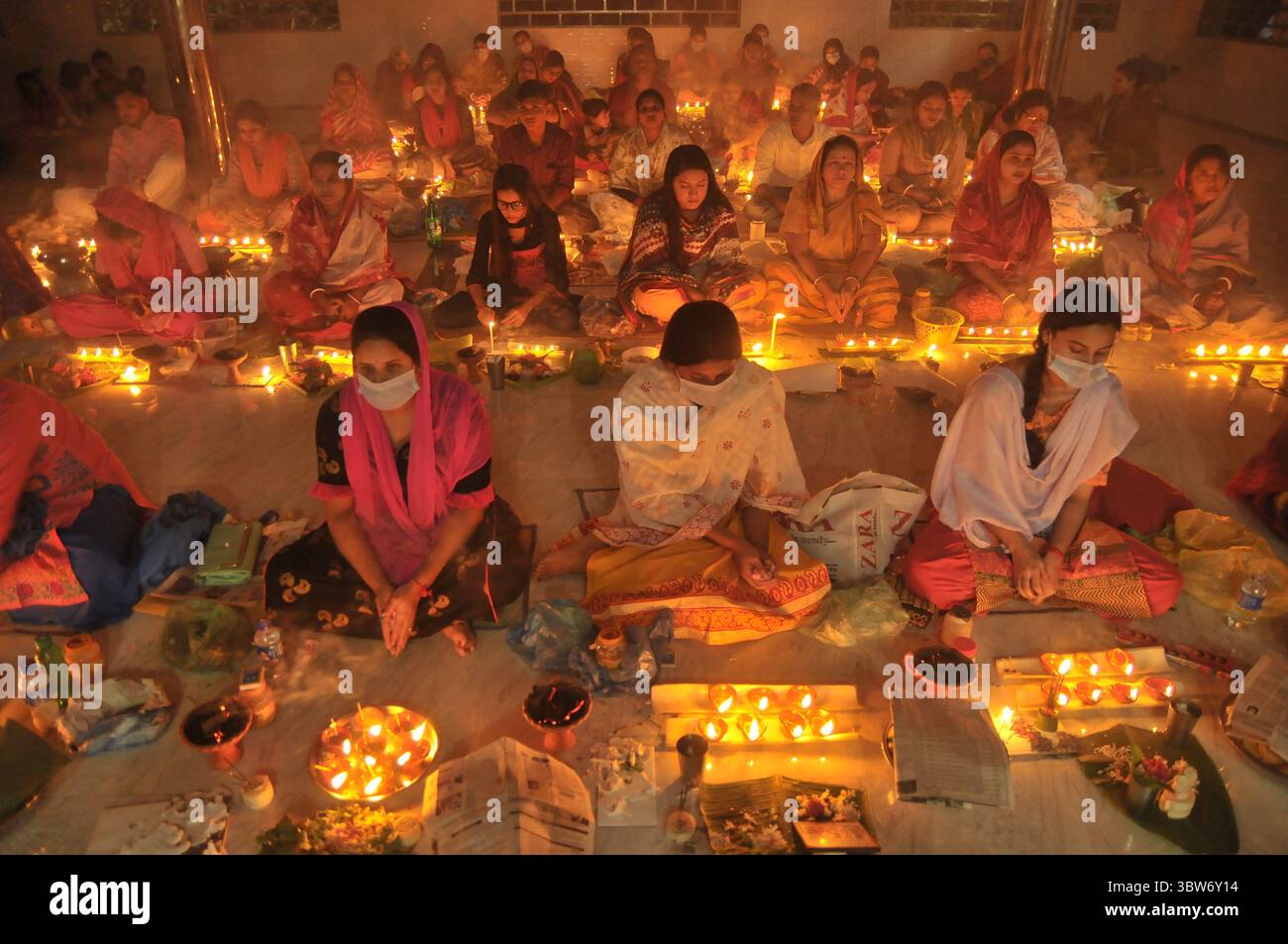 November 10, 2020: Under the Shadow of Corona Virus, Hindu devotees sit together on the floor at Sri Sri Loknath Brommochari  babar Ashrom and Mondir temple to observe Rakher Upabash ritulas, in Korer Para, Sylhet, Bangladesh. (Credit Image: © Md Rafayat Haque Khan/ZUMA Wire) Stock Photo
