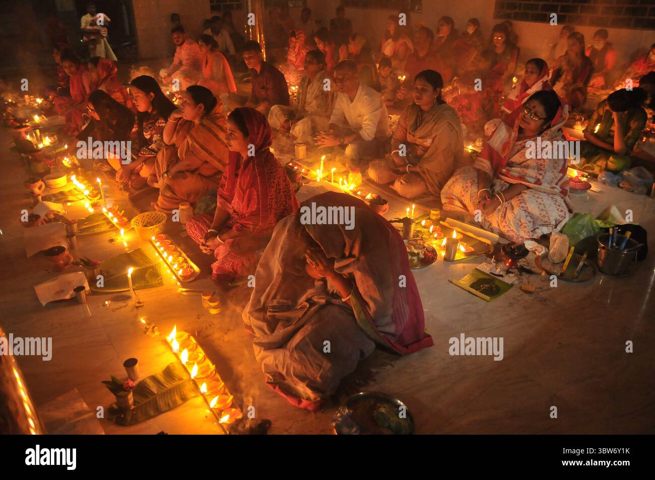 November 10, 2020: Under the Shadow of Corona Virus, Hindu devotees sit together on the floor at Sri Sri Loknath Brommochari  babar Ashrom and Mondir temple to observe Rakher Upabash ritulas, in Korer Para, Sylhet, Bangladesh. (Credit Image: © Md Rafayat Haque Khan/ZUMA Wire) Stock Photo