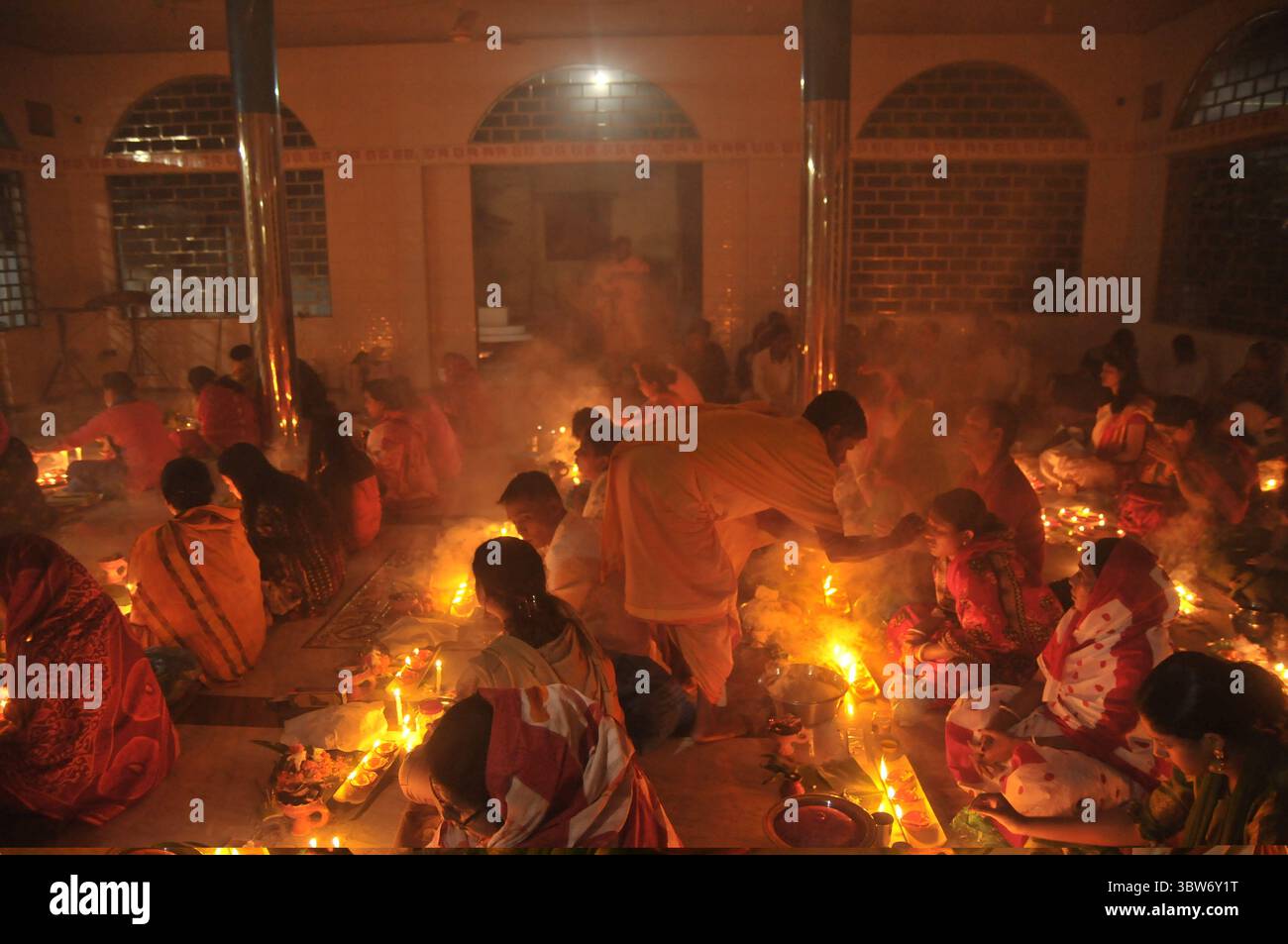 November 10, 2020: Under the Shadow of Corona Virus, Hindu devotees sit together on the floor at Sri Sri Loknath Brommochari  babar Ashrom and Mondir temple to observe Rakher Upabash ritulas, in Korer Para, Sylhet, Bangladesh. (Credit Image: © Md Rafayat Haque Khan/ZUMA Wire) Stock Photo