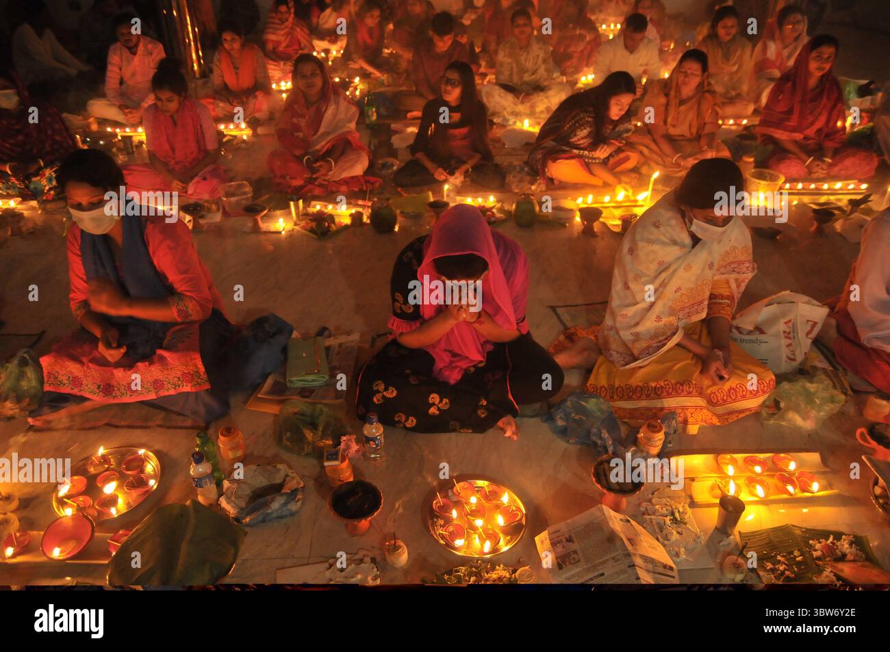 November 10, 2020: Under the Shadow of Corona Virus, Hindu devotees sit together on the floor at Sri Sri Loknath Brommochari  babar Ashrom and Mondir temple to observe Rakher Upabash ritulas, in Korer Para, Sylhet, Bangladesh. (Credit Image: © Md Rafayat Haque Khan/ZUMA Wire) Stock Photo