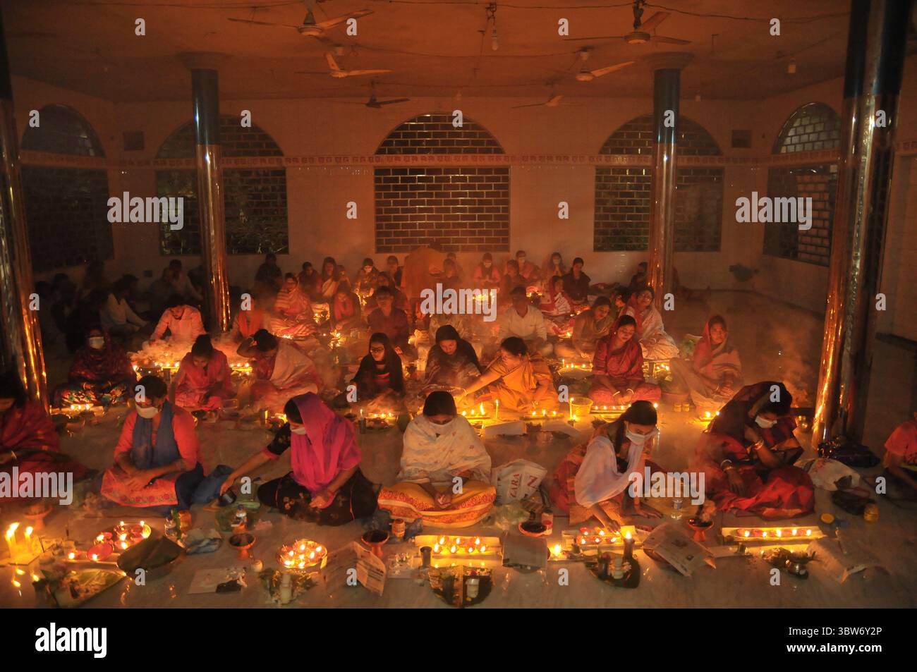 November 10, 2020: Under the Shadow of Corona Virus, Hindu devotees sit together on the floor at Sri Sri Loknath Brommochari  babar Ashrom and Mondir temple to observe Rakher Upabash ritulas, in Korer Para, Sylhet, Bangladesh. (Credit Image: © Md Rafayat Haque Khan/ZUMA Wire) Stock Photo
