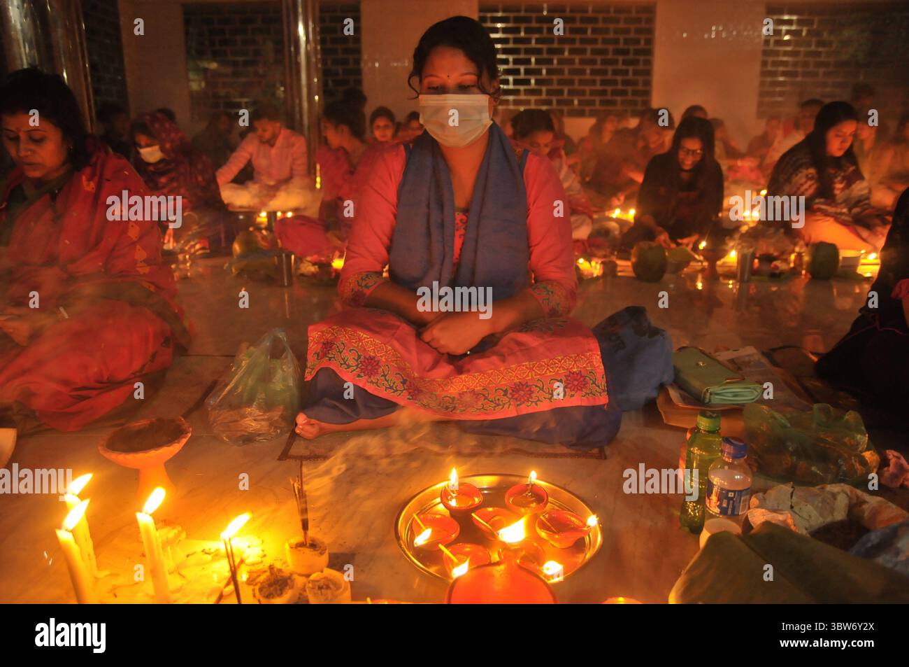 November 10, 2020: Under the Shadow of Corona Virus, Hindu devotees sit together on the floor at Sri Sri Loknath Brommochari  babar Ashrom and Mondir temple to observe Rakher Upabash ritulas, in Korer Para, Sylhet, Bangladesh. (Credit Image: © Md Rafayat Haque Khan/ZUMA Wire) Stock Photo