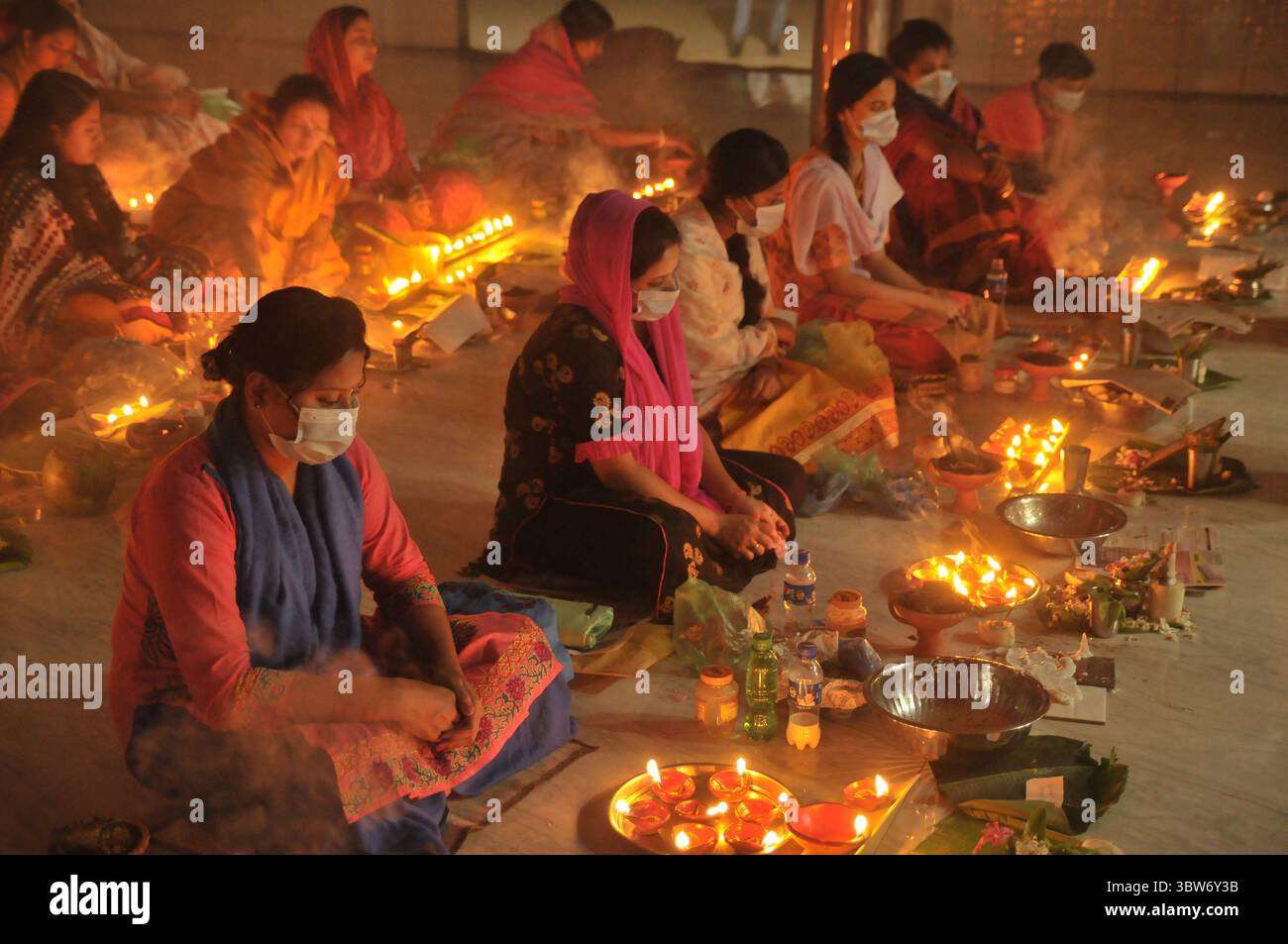 November 10, 2020: Under the Shadow of Corona Virus, Hindu devotees sit together on the floor at Sri Sri Loknath Brommochari  babar Ashrom and Mondir temple to observe Rakher Upabash ritulas, in Korer Para, Sylhet, Bangladesh. (Credit Image: © Md Rafayat Haque Khan/ZUMA Wire) Stock Photo