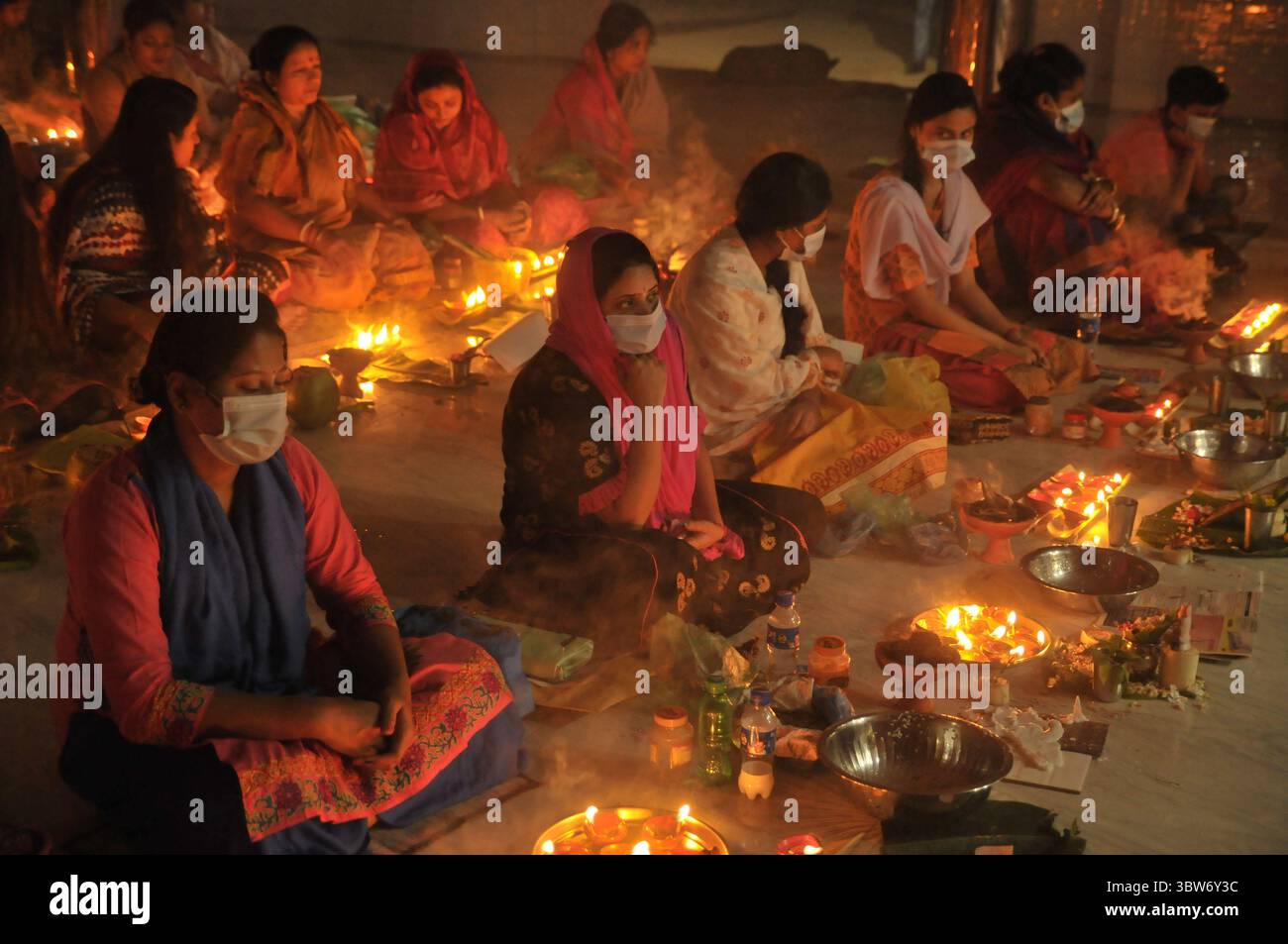 November 10, 2020: Under the Shadow of Corona Virus, Hindu devotees sit together on the floor at Sri Sri Loknath Brommochari  babar Ashrom and Mondir temple to observe Rakher Upabash ritulas, in Korer Para, Sylhet, Bangladesh. (Credit Image: © Md Rafayat Haque Khan/ZUMA Wire) Stock Photo
