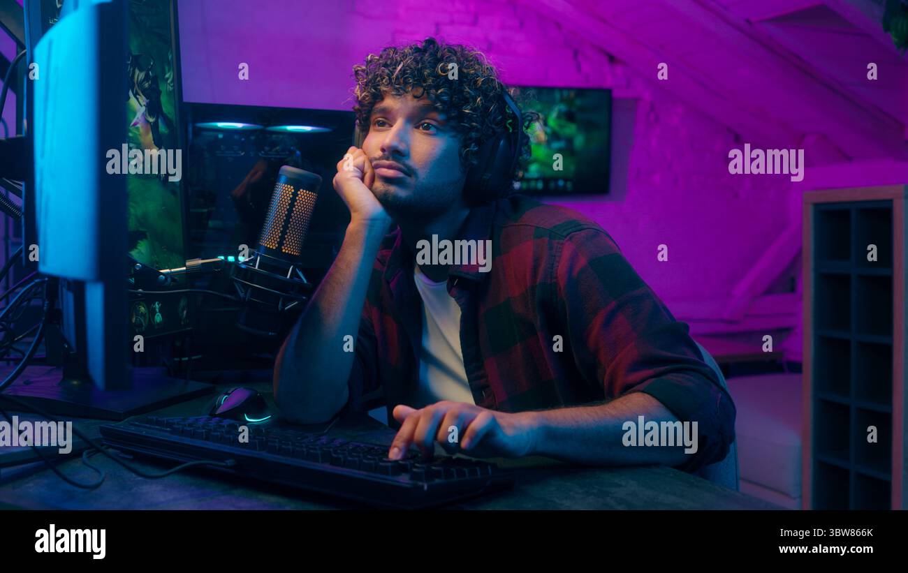 Arabian Indian bored sleepy man yawning playing game guy typing ...