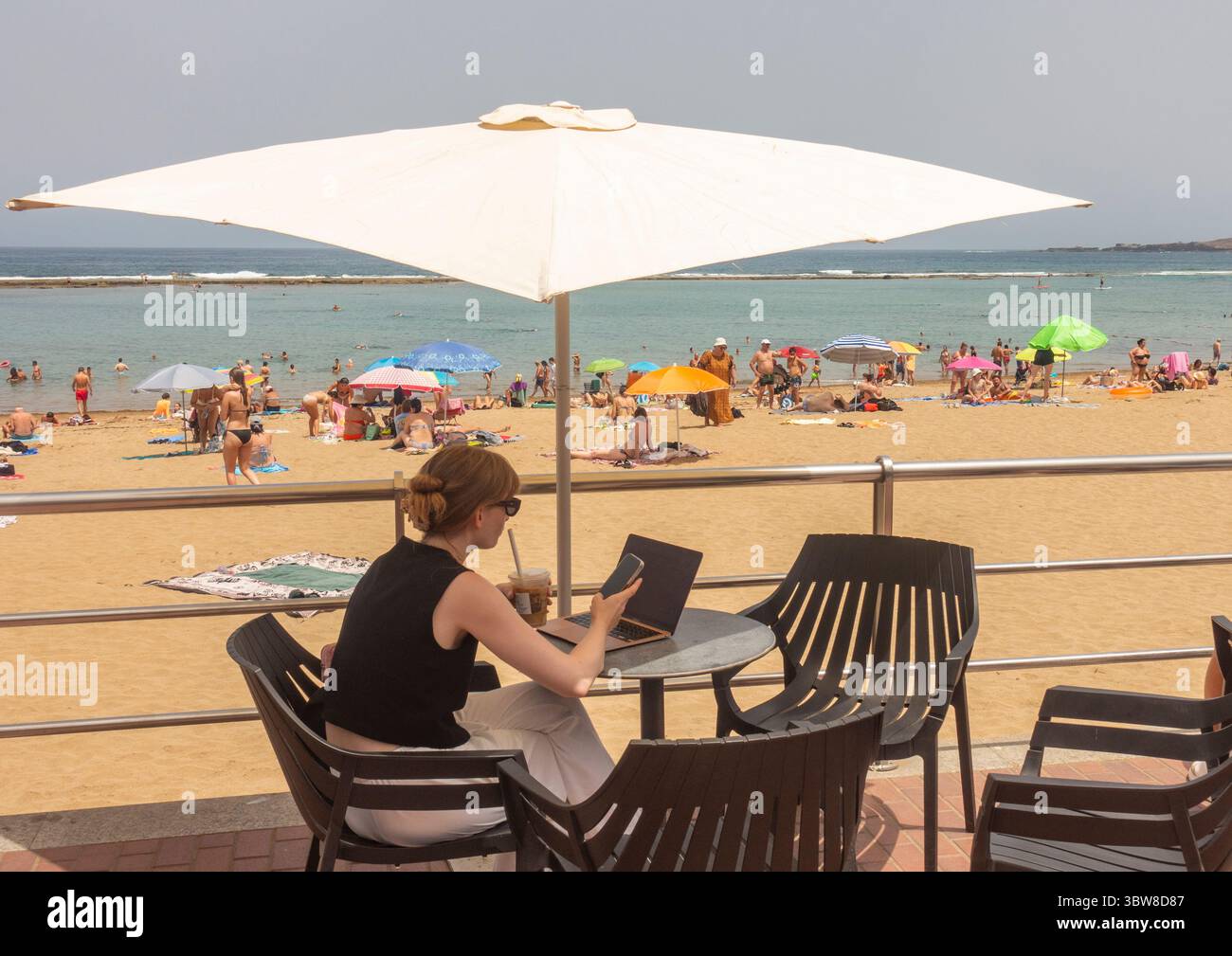 Las Palmas, Gran Canaria, Canary Islands, Spain.16th July, 2025. Tourists, many British, swelter on the city beach in Las Palmas as the midday temperature registers 38.7 degrees Celcius in the south of Gran Canaria. A cocktail of high temperatures and winds blowing in from the Sahara has activated an orange health and forest fire risk alert throughout the Canary Islands. Credit: Alan Dawson/Alamy Live News Stock Photo